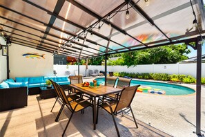 Outdoor dining for 6, extra patio seating, and shaded comfort under the canopy.