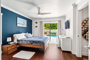 First-floor Bedroom 1: walk-in closet, full bath, and work space.