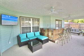 The outdoor patio room, screened in and covered from the elements.