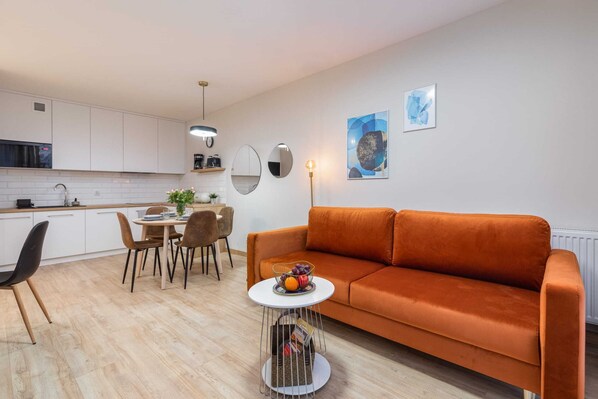 A seating area with an extremely comfortable sofa and TV.