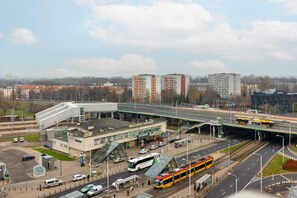 A wide-angle cityscape showing public transportation and nearby infrastructure, ideal for a convenient location.