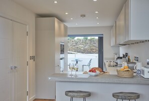 5 The Sands, Polzeath. Modern well-equipped kitchen opening up to the front of the property