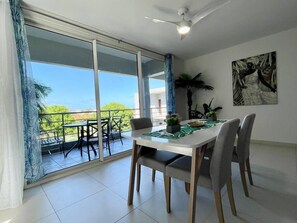 Living room with dining table & balcony