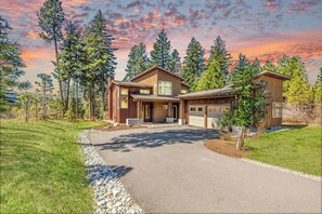 Striking Mountain Home Exterior W/ Timber Peaks + Lush Landscaping