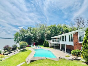 Lake front Backyard with in ground swimming pool & Lounge Chairs