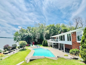 Lake front Backyard with in ground swimming pool & Lounge Chairs