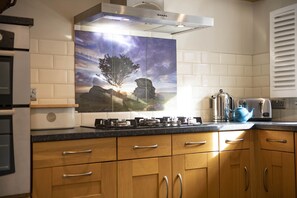 Ground floor: Kitchen featuring large gas hob and double oven