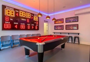 [Game Room] You Will Not Find Another Game Room Like This One! There is a Pool Table, an Electronic Scoreboard, a Central Bar with Seating for 5 and a Mini Fridge.