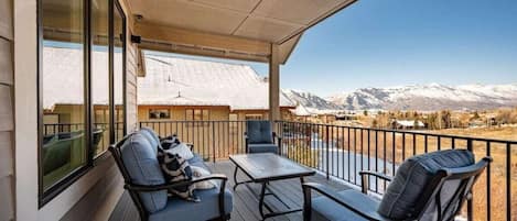 Enjoy the views from the cozy seating on upper level covered deck!