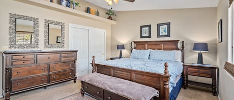 Primary suite with king bed and TV