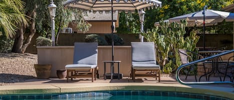 Four comfy lounge chairs are around the pool, and a sectional on the patio