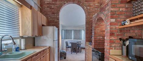 Kitchen with unique brick work throughout