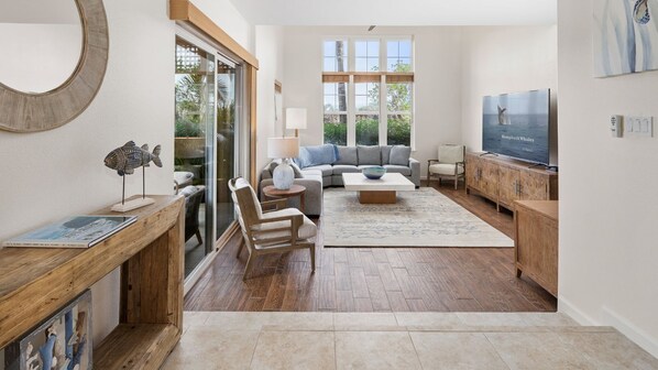 living area features 18-foot ceilings and an 84” LG TV