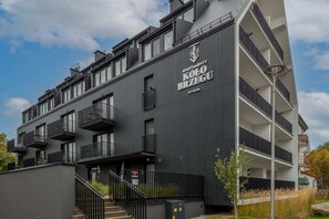 A view of the modern apartment building with sleek architecture and black detailing.