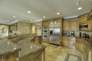 Sand Castle Kitchen - The granite kitchen island and countertops offer generous space to prepare your daily catch, while sampling a California Central Coast wine pairing.