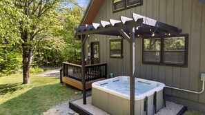 Under string lights, the hot tub is perfect after a day of exploring or skiing