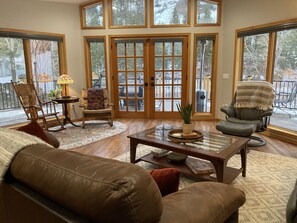 living room with picture windows looking out onto river