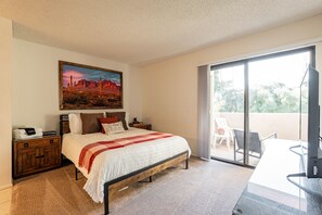 Primary bedroom with queen bed and balcony access