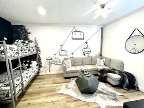 Special touches abound ... like this  rec room/ bedroom with a  hang-out area with PS-5 and a huge 75" smart TV, plus the bunk area