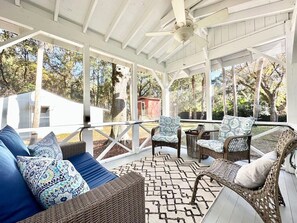 A charming screened-in porch for relaxing afternoons.  Outdoor seating and a view! 3705 Hartnett Blvd, Isle of Palms, SC | IOP Escapes