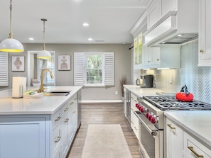 Open kitchen layout with plenty of room for food prep and clean-up!  Stainless steel appliances including a Wolf Range. 3705 Hartnett Blvd, Isle of Palms, SC | IOP Escapes