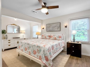 Primary Suite Bedroom with California King sized bed, 2 nightstands, Television, ceiling fan. 3705 Hartnett Blvd, Isle of Palms, SC | IOP Escapes
