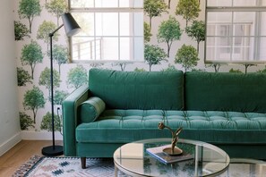 Stretch out across the rich deep green velvet couch and feel yourself transport to a historic grove.