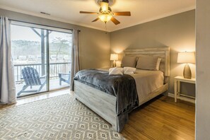 This is the downstairs bedroom - step out onto the deck or gaze onto the lake through your private deck access.