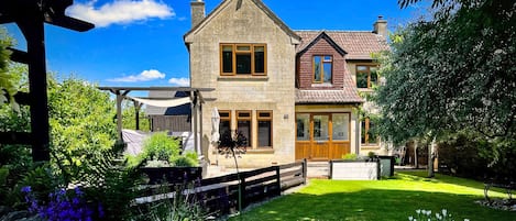 Front elevation of house and front garden. Accessed via the carpark.