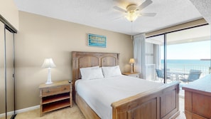 The king suite welcomes you with a plush king bed enrobed in fine, stark white linens, ready to comfortably support you as you drift off to sleep after a busy day at the beach.
