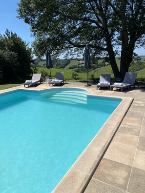 South facing large heated sole use pool with loungers umbrellas and beach towels