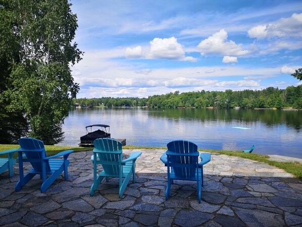 Muskoka chairs on the granite patio, outside the walkout (unfinished basement)