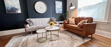 Bright living room with sofa and love seat.