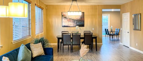 Our spacious well lit living room comes w/ a couch,  coffee table & dining area