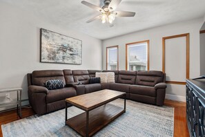 Living room with 65" Smart TV and wrap-around sectional for 6