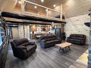 Open concept living room and kitchen with spiral staircase to upstairs bedrooms.