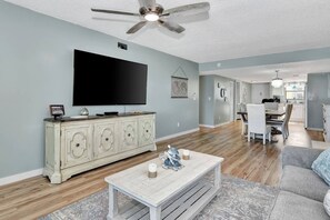 Living room leading to kitchen and dining 