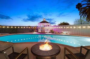 Keep warm around the fire pit with the pool and gazebo in view