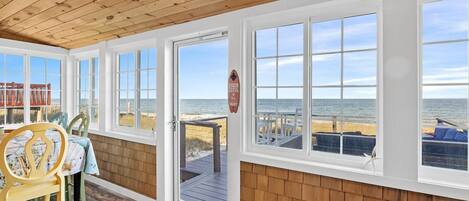 Enclosed Porch with dining area for 6, beautiful ocean breezes with the windows open.  Read a book or relax in the lounge chairs