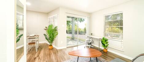 Tastefully decorated living room with dedicated workspace and an unfolding sofa.