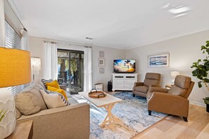 TV cabinet has board games, decks of cards, and books for beach reading.