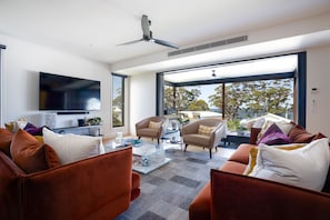 Living space leading out to large outdoor living and overlooking the water
