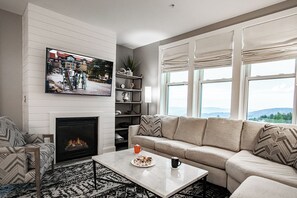 The living area features a cozy gas fireplace, perfect for relaxing after a long day of fun on the slopes!