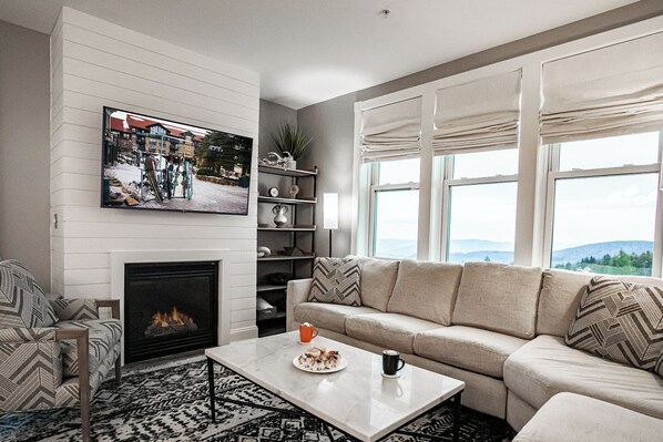 The living area features a cozy gas fireplace, perfect for relaxing after a long day of fun on the slopes!