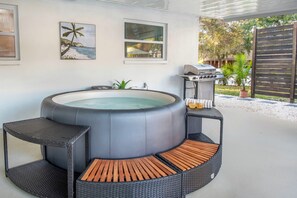 Relax in the hot tub with hydrotherapy jets under the covered patio