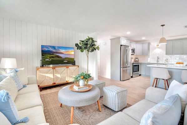 Main living space with comfortable sofas and a fully equipped kitchen