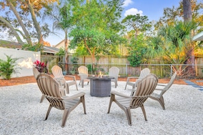 Outdoor fire pit amid lush, tropical landscaping