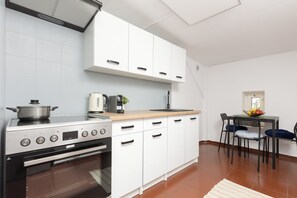 A modern kitchen with white cabinets, ample countertop space, and equipped with all necessary appliances.