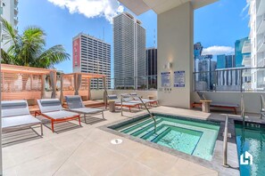 There's a shared jacuzzi at the swimming pool on the deck!