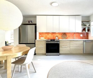 Kitchen is well-equipped with new stainless steel appliances.